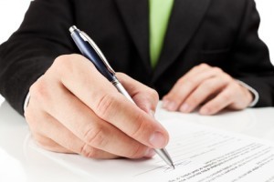 Businessman signing a document.
